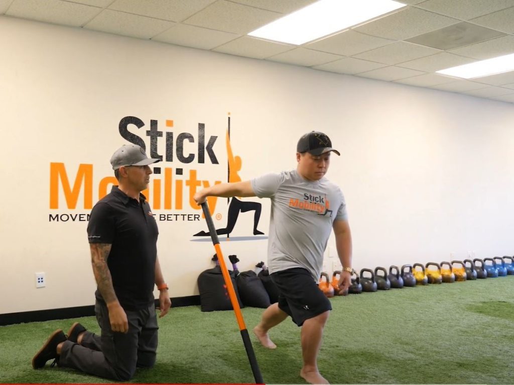Biceps opener with stick mobility exercise
