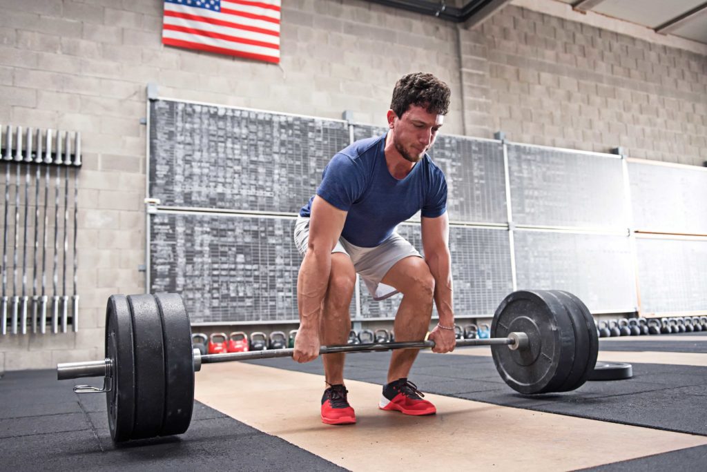 Athlete starting a deadlift in a crossfit gym