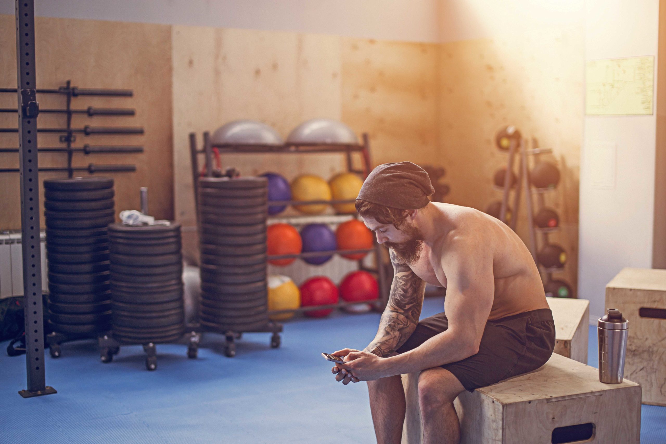 Muscular young athletic built athlete taking a break from hard workout