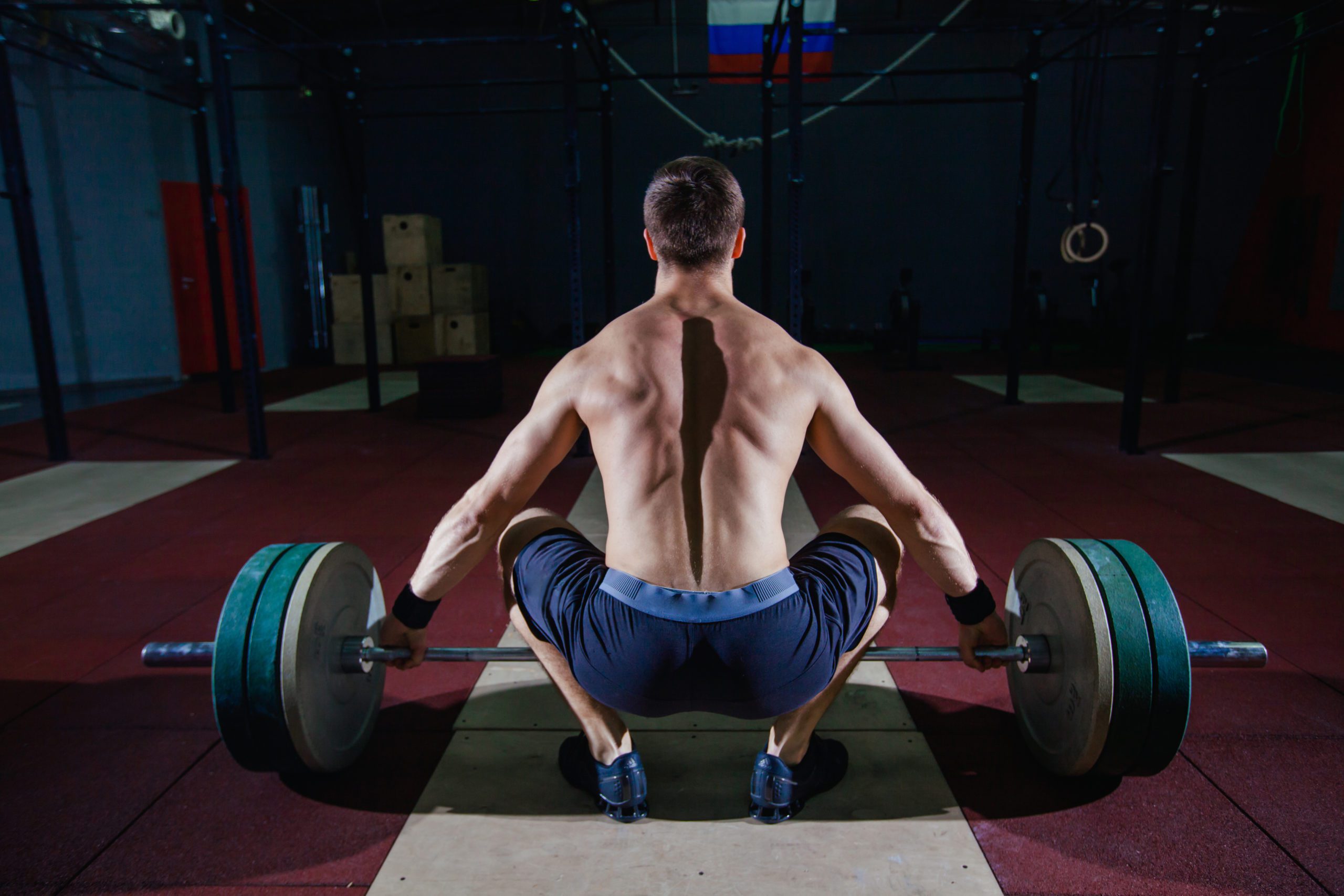 Strong, muscular man performing the kettlebell swing