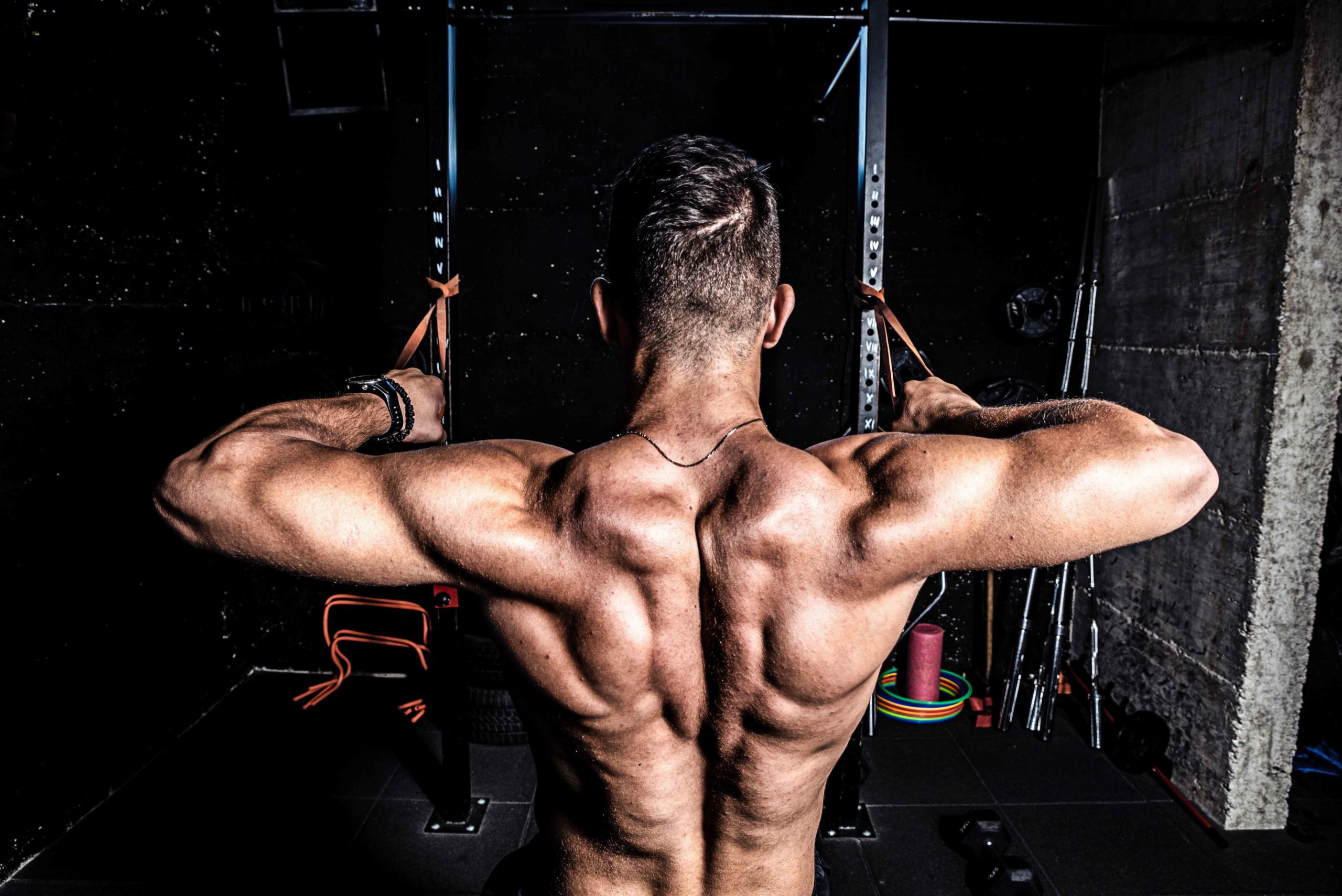 strong muscular man doing the face pull exercise