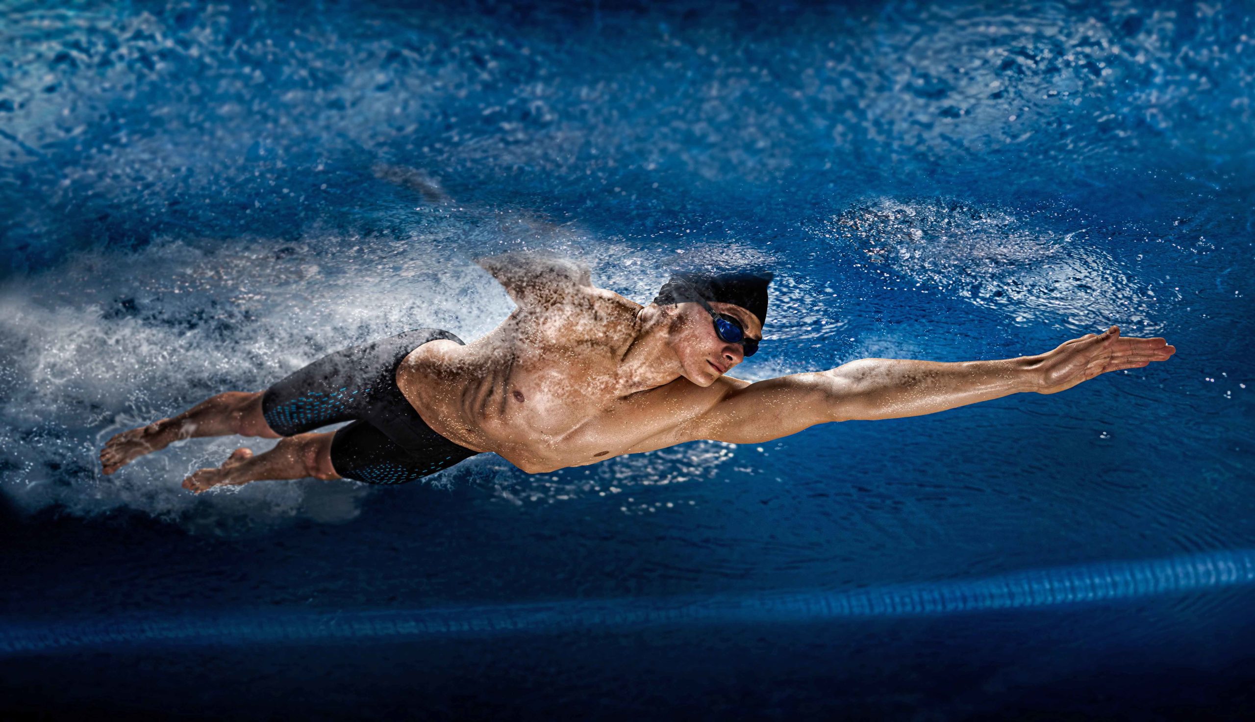 Competitive swimmer man swimming underwater 
