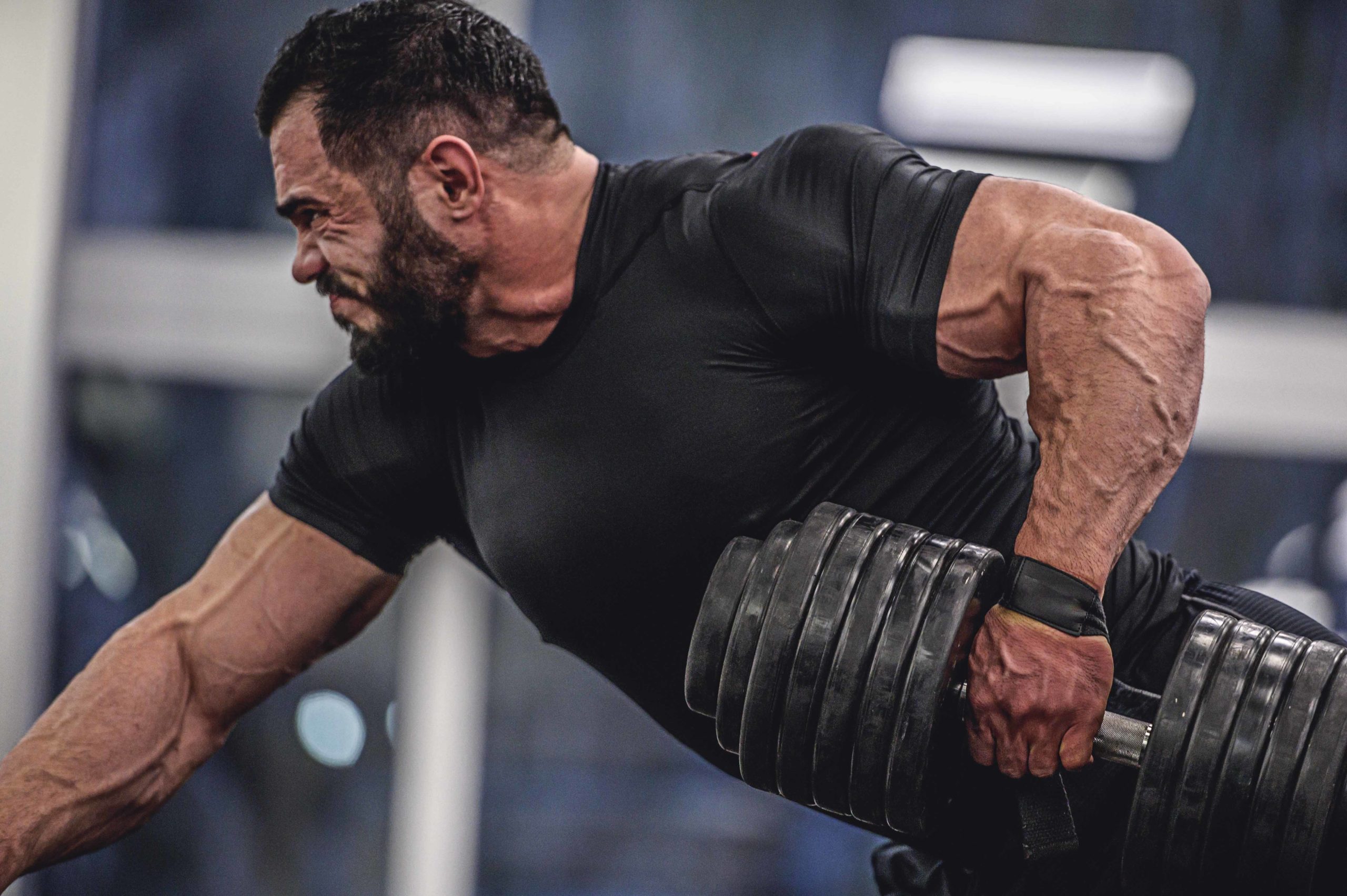 Strong, muscular man performing the kettlebell swing