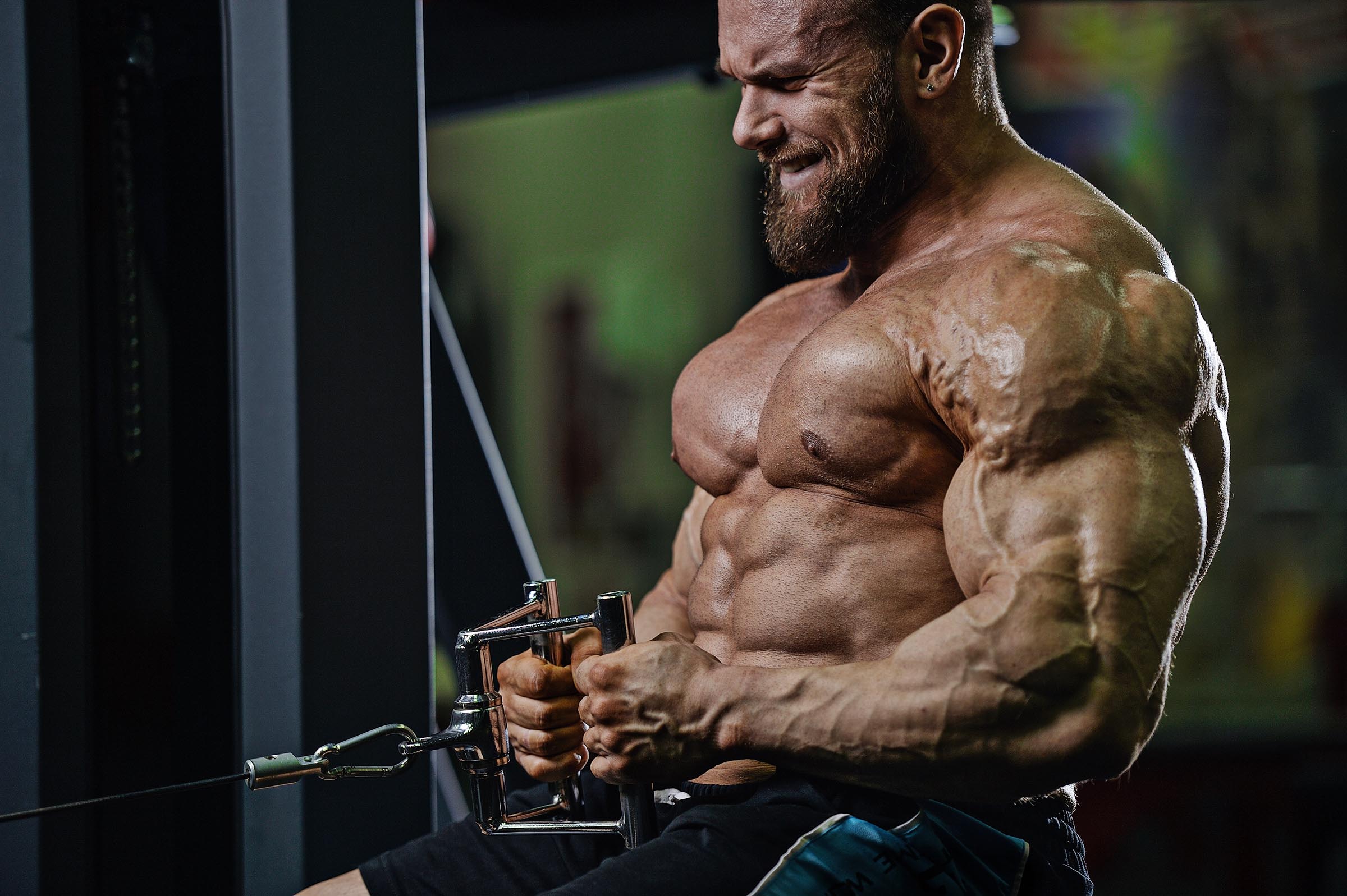 Strong, muscular man performing the kettlebell swing