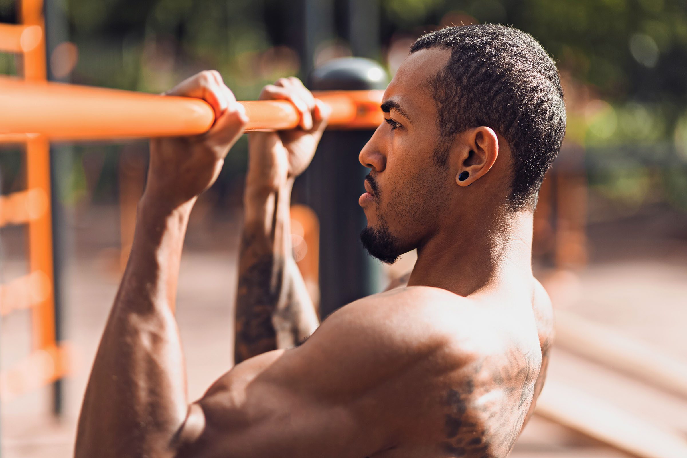 Crossfit man working out pull-ups on chin-up bar