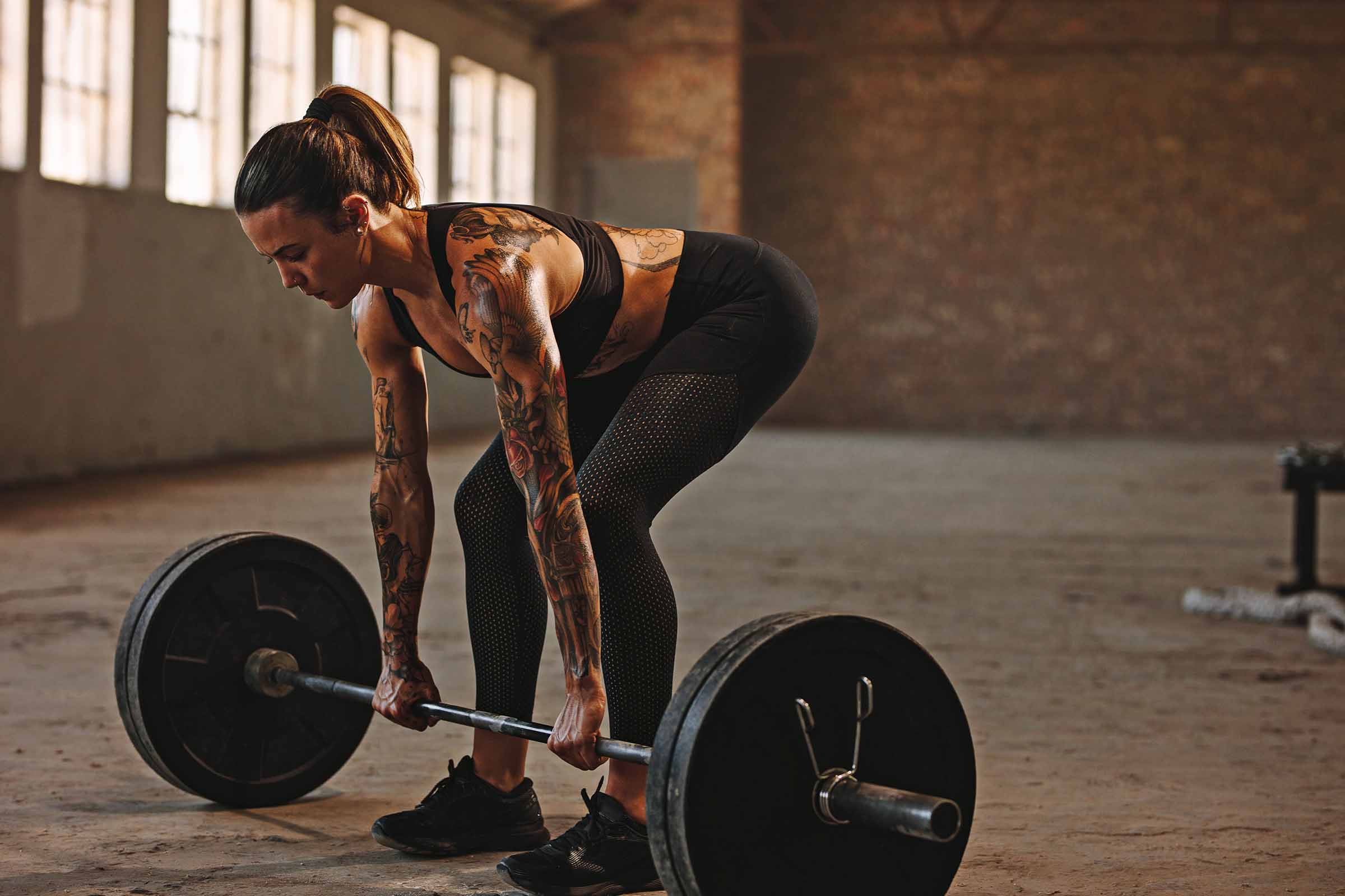 Woman in gym doing deadlift