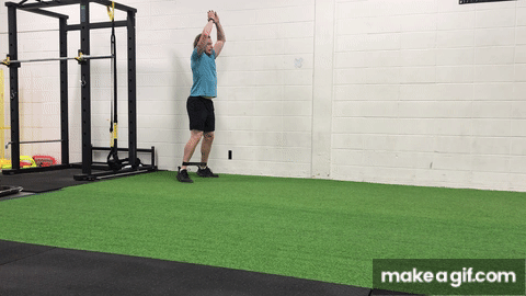 Banded double leg hop on indoor turf field in gym with white background