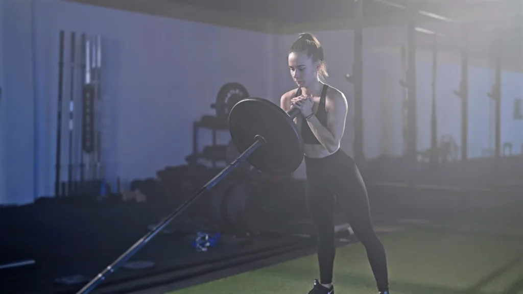 Fitness woman exercise landmine squat with barbell weightlifting