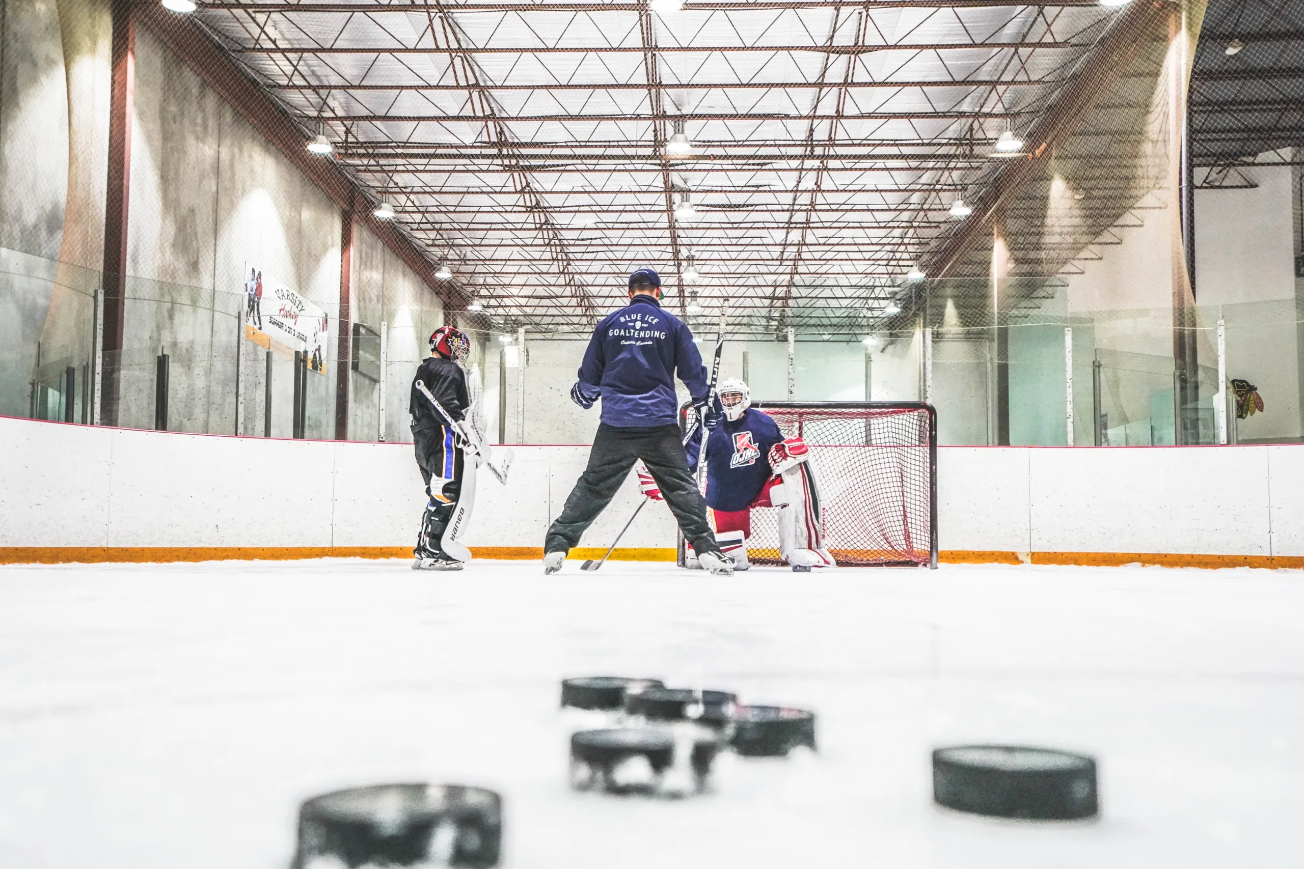 A picture of a hockey players talking to each other.