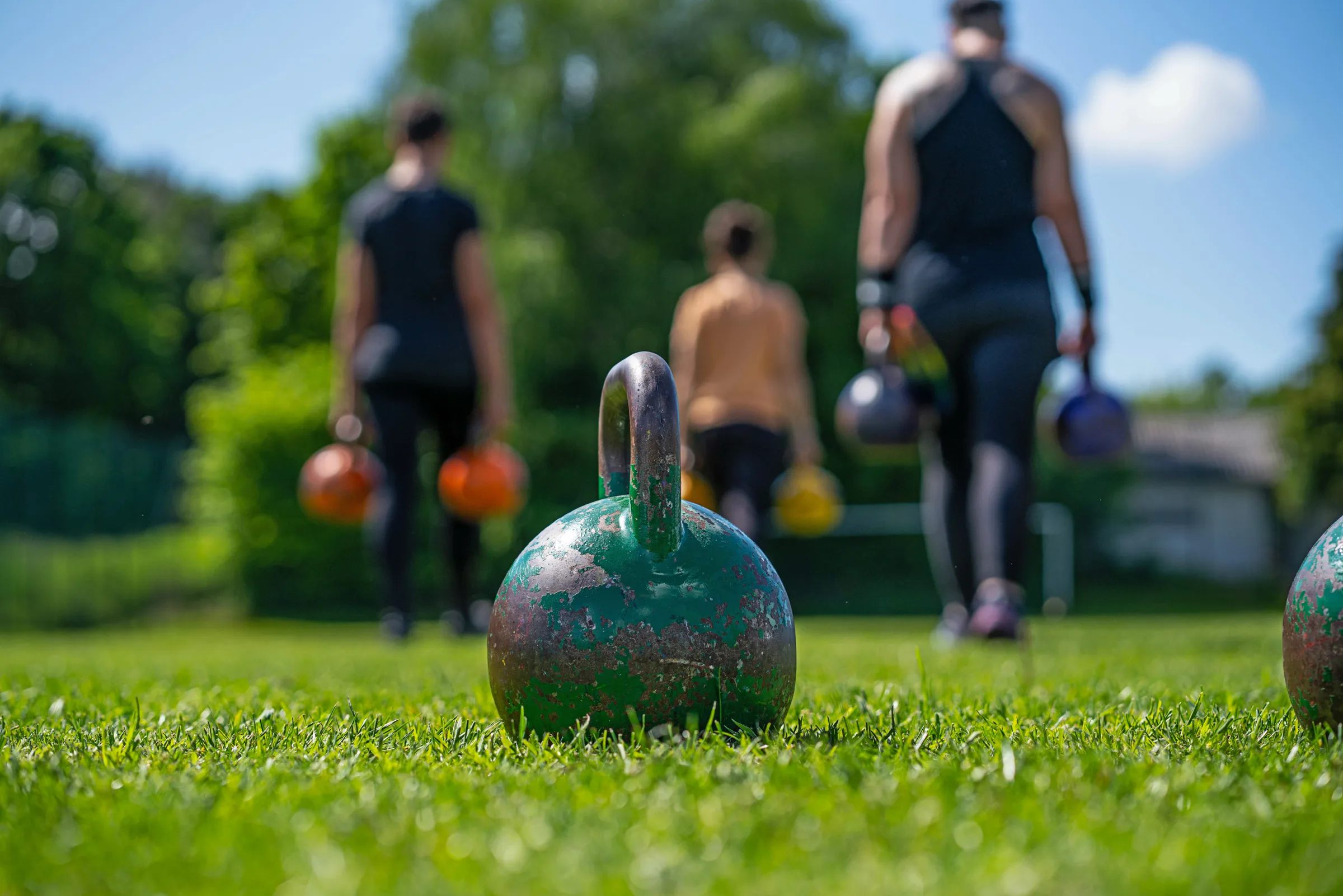 kettlebells in green grass - fitness concept outdoors
