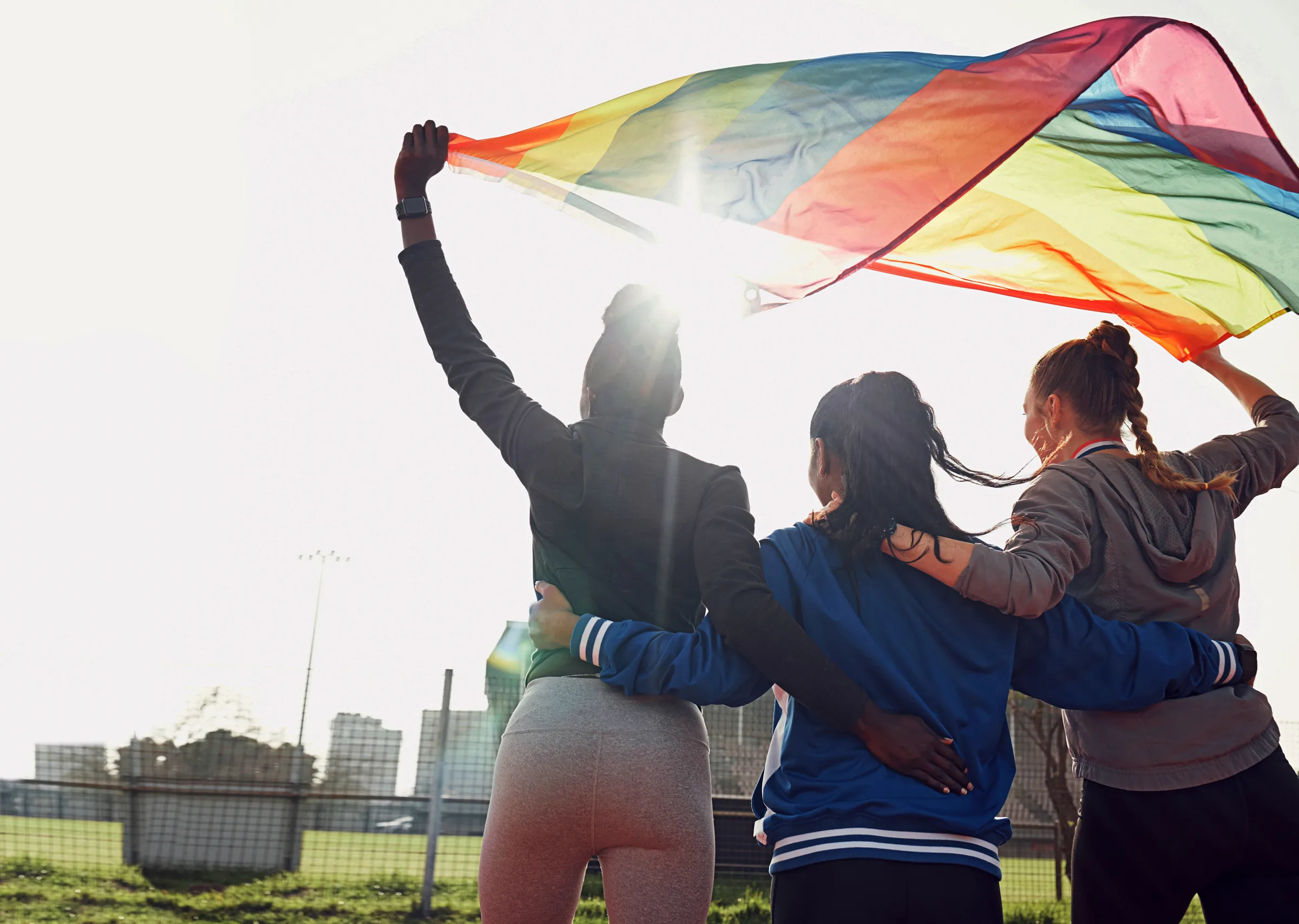 Fitness, rainbow flag and female athletes outdoor for pride, health and wellness achievement. Sports, love and women friends embracing while walking for political homosexual equality and lgbtq rights BIRTHFIT: Training for Bad*ss Moms header image