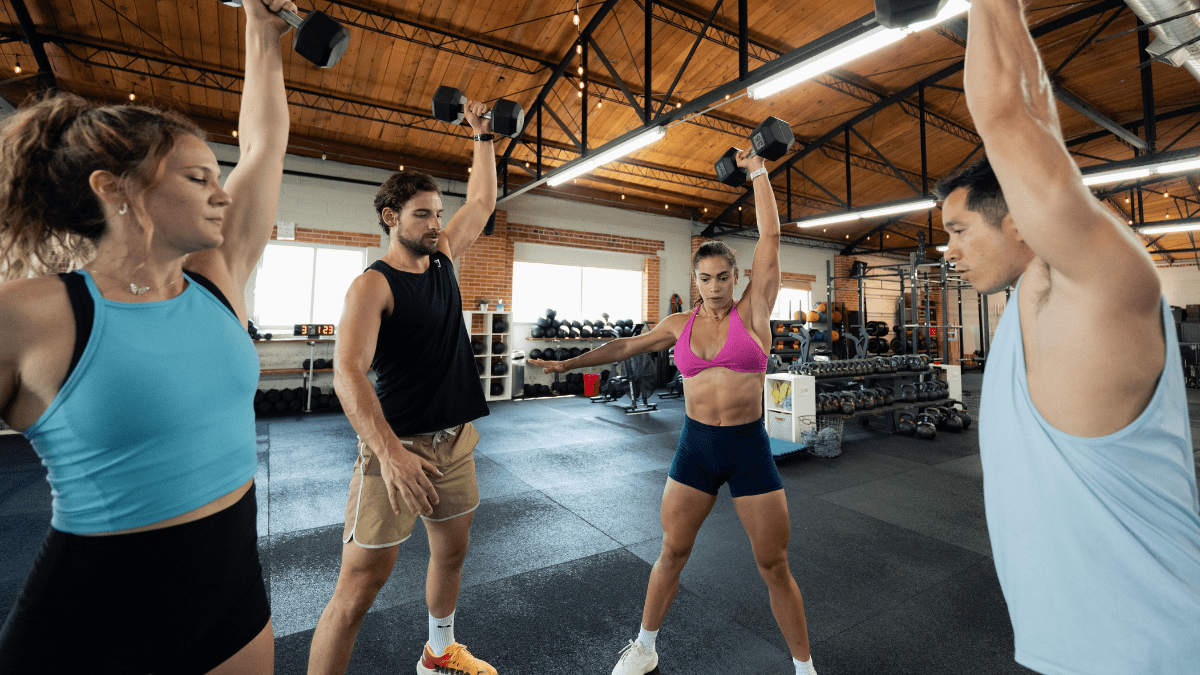 Group of TrainHeroic athletes doing an exercise swap for cleans